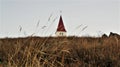 Low angle shot of dome of Hellnar Church in field of south coast of Snaefellsnes peninsula Iceland.