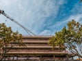 Low angle shot of elevating crane and building construction site Royalty Free Stock Photo