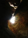 Low angle shot of the entrance of Ghar in-Naghag cave in limestone cliffs, Maltese Islands, Malta