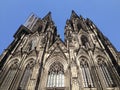 Low angle shot of the facade of the beautiful Cologne Cathedral in Germany, against a clear blue sky