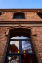 Low angle shot of the facade of a modern brick building under a blue clear sky Royalty Free Stock Photo