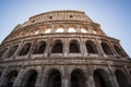 Low angle shot of a famous Colosseum in Rome, Italy with a clear blue sky in the background