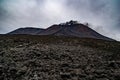 Low angle shot of the famous Etna volcano smoky and ashy top under a cloudy sky in Sicily, Italy Royalty Free Stock Photo