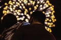 Low-angle shot of the father holding his daughter with the bright firework in the background Royalty Free Stock Photo