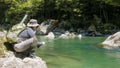 Low angle shot of an fly angler hooking a trout Royalty Free Stock Photo