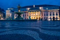 Low angle shot of fountain and illuminated facade of National Theatre Lisbon