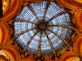 Low angle shot of the glass beautiful dome ceiling of Galeries Lafayette in Paris