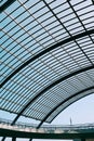 Low angle shot of a glass roof of a modern building under the blue sky Royalty Free Stock Photo