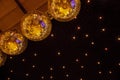 Low angle shot of gold disco balls on dark background