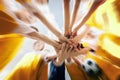 Low angle shot of a group of sports team forming a huddle with their hands