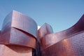 Low angle shot of the Guggenheim Bilbao museum building with a view of the evening blue sky