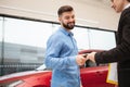 Car dealer selling new autos at the dealership Royalty Free Stock Photo