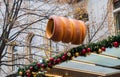 Low angle shot of a hanging trdelnik signboard surrounded by buildings and trees
