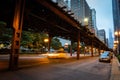 Low-angle shot of high subway public rail train over a bridge in Chicago city at night Royalty Free Stock Photo