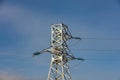 Low angle shot of high voltage electric tower and power lines in the city. Blue sky background. Barnaul, Siberia, Russia Royalty Free Stock Photo