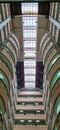 Low angle shot of the interior of a tall campus building, in an art deco style of interior architecture. Skylight elements on the Royalty Free Stock Photo