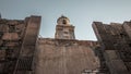 Low angle shot of an Italian church tower with a big wall in the foreground Royalty Free Stock Photo