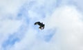 Low angle shot of a kite flying in the cloudy blue sky Royalty Free Stock Photo