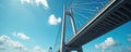 Low angle shot of large modern cable stayed bridge against bright blue sky with white clouds. Impressive architecture structure Royalty Free Stock Photo
