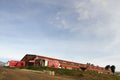 Low angle shot of a large warehouse with semi-trailer trucks parked outside Royalty Free Stock Photo