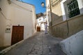 Low angle shot of local male opening a door in an alley in Alcala del Jucar,Albacete province,Spain