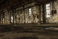 Low angle shot of a long brick wall with windows in an abandoned factory