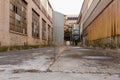 Low angle shot looking up between buildings at an abandoned factory site