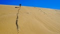 Low angle shot of a male walking in a desert in Uruguay