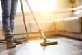 Low section of man cleaning hardwood floor with vacuum cleaner Royalty Free Stock Photo