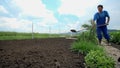 Low angle shot of man throwing the earth with a shovel in slow motion