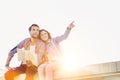 Low angle view of man holding map while sitting and talking to his girlfriend Royalty Free Stock Photo