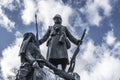 Low angle shot of a metal statue of a soldier and a woman Royalty Free Stock Photo