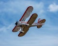 Low angle shot of a model Waco biplane in flight overhead on a sunny day in Missouri Royalty Free Stock Photo