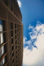 Low angle shot of a modern building with a blue sky in the background Royalty Free Stock Photo