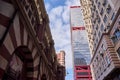 Low angle shot of modern buildings against a blue sky in Shun Tak Centre, Hong Kong