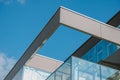 Low angle shot of a modern business building with sleek architecture under a bright blue sky Royalty Free Stock Photo