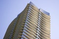 Low angle view of a modern corporate building with yellowish overhangs in each floor.