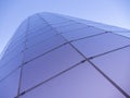 Low angle shot of a modern glass building on a clear blue sky background Royalty Free Stock Photo