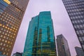 Low angle shot of a  modern glass building in Japan at dusk with reflections of other buildings Royalty Free Stock Photo