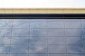 Low angle shot of modern glass windows with the reflection of the sky and clouds during daylight Royalty Free Stock Photo