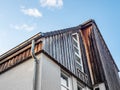 Low angle shot of a modern wooden house against a blue sky Royalty Free Stock Photo