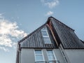 Low angle shot of a modern wooden house against a blue sky Royalty Free Stock Photo