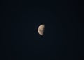 Low angle shot of a moon in the first quarter of its phase Royalty Free Stock Photo