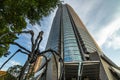 Low angle shot of the Mori Tower in Tokyo Japan against a cloudy blue sky Royalty Free Stock Photo