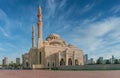 Low angle shot of a mosque in Sharjah, United Arab Emirates with a blue sky in the background Royalty Free Stock Photo