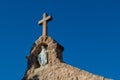 Low angle shot of Mother Mary statue and stone cross on the top of catholic church in Arizona Royalty Free Stock Photo