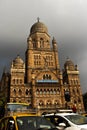 Low-angle shot of the Mumbai Central Railway station under heavy dark clouds