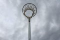 Low angle shot of a netball hoop under the overcast sky