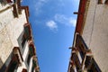 A low angle shot o white buildings under a blue sky Royalty Free Stock Photo