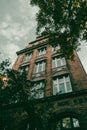 Low-angle shot of an old apartment building and trees in the Lazarz district Royalty Free Stock Photo